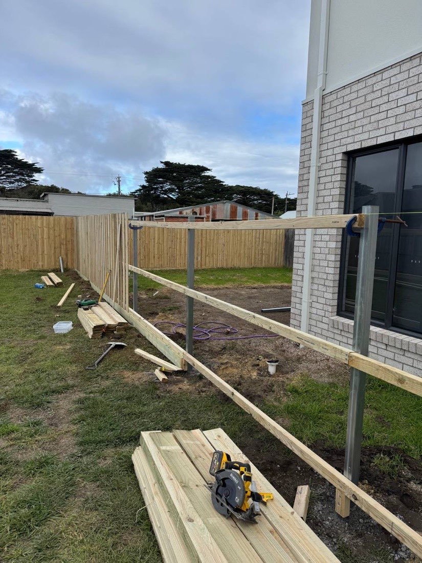 Galvanised steel posts and timber rails part-way through a paling fence install by Drysdale Fencing in Geelong